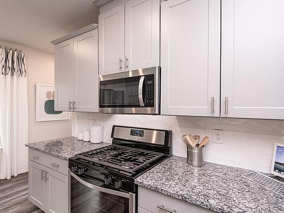 Photo of model home for illustration purposes only, the actual home has white cabinets