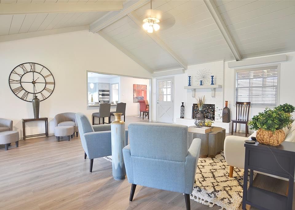 Family Room with cathedral ceiling, fireplace, new flooring & paint and 2" blinds