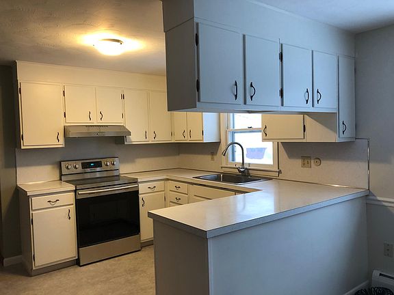 Kitchen with new stove and refrigerator.