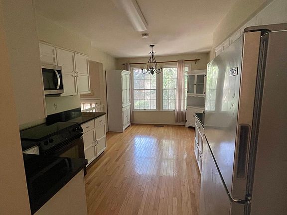 Kitchen. Stainless steel appliances with gorgeous black granite countertops and freshly painted white cabinets.