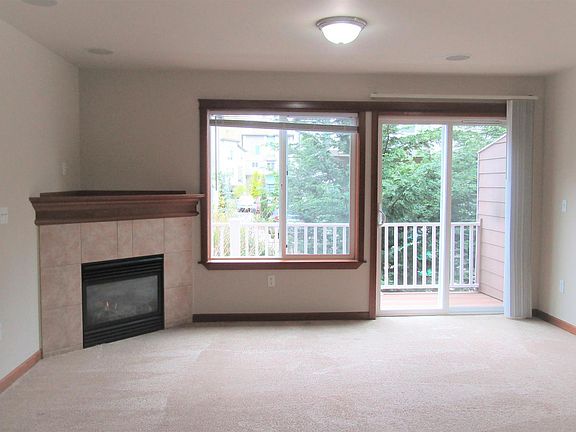 Living Room with Corner Fireplace & Balcony