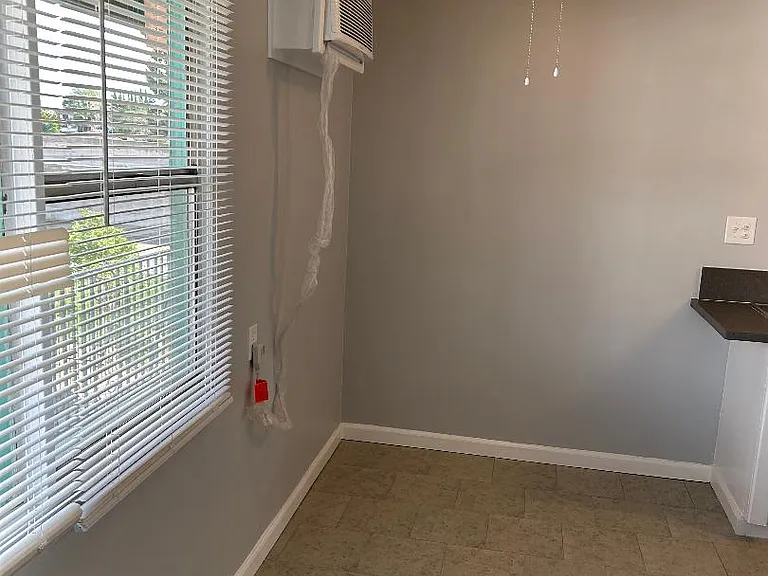Dining area with brand new wall unit A/C, brand new fan with light and brand new tile floor
