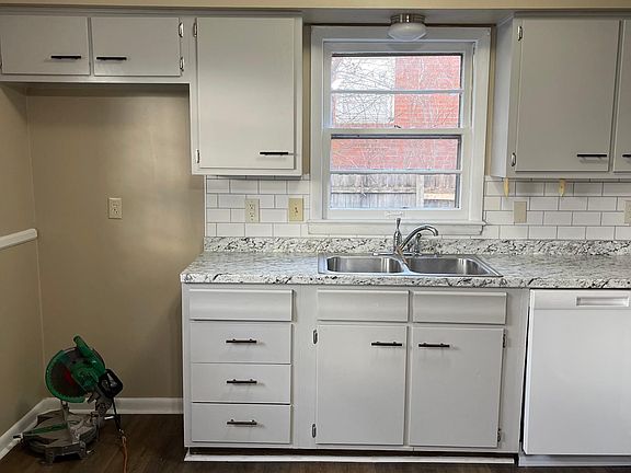 Kitchen has been updated with new flooring, painted cabinets, new counter tops, cabinet pulls, and new dishwasher.