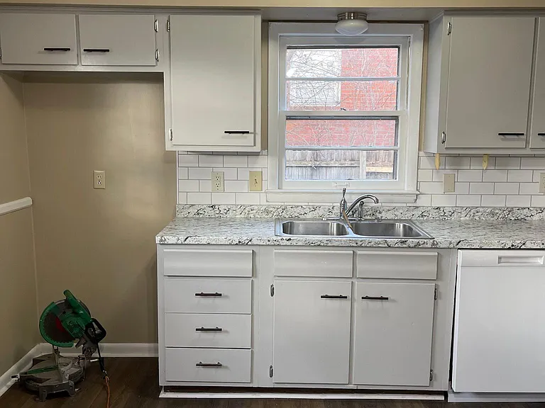 Kitchen has been updated with new flooring, painted cabinets, new counter tops, cabinet pulls, and new dishwasher.