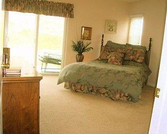 master bedroom with slider to patio