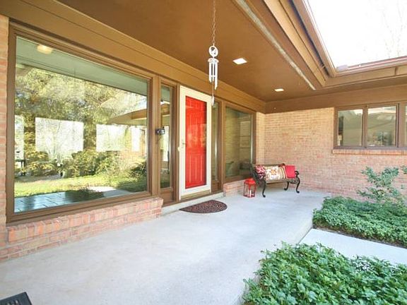 A covered porch at the front of the home is where you begin to notice all the windows of the home.