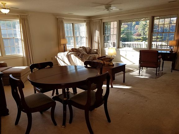 Dining room table has a leaf to seat more guests.