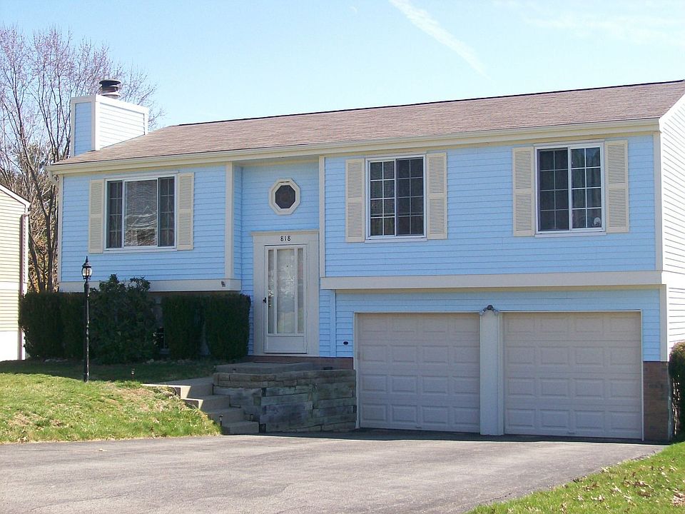 Exerior freshly painted with newer garage doors and paved driveway.