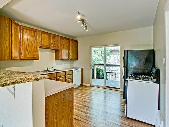 large kitchen with deck to backyard