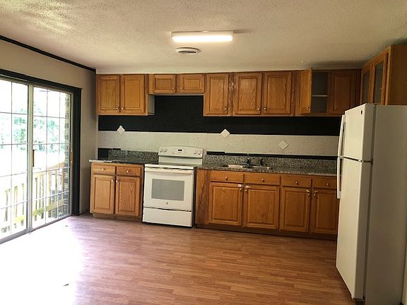 Newly constructed kitchen with sliding glass door leading to the outdoors.
