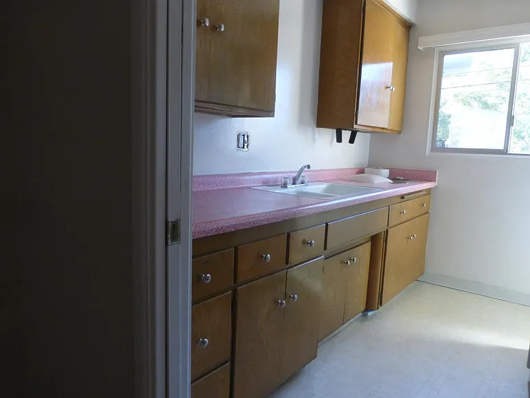 Kitchen sink and natural wood cabinets