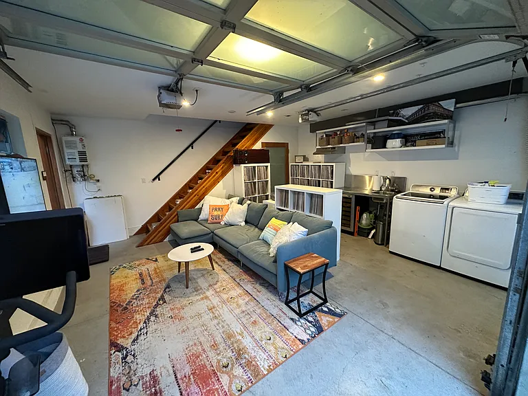 First floor guesthouse, living room area, washer/dryer, sink