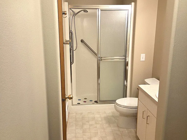 View from the primary bedroom walk-in closet into the ensuite bathroom.