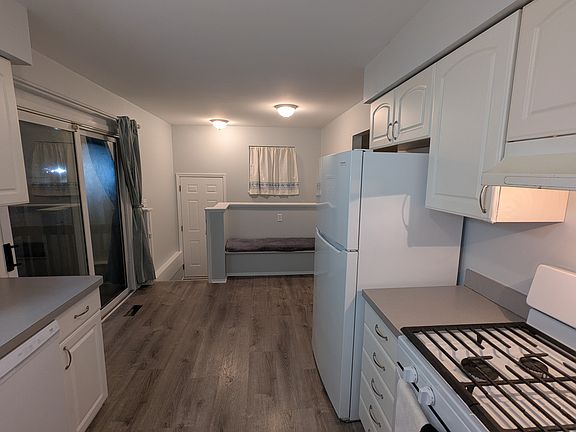 Eat in kitchen space with built in bench offers great view to scenic backyard