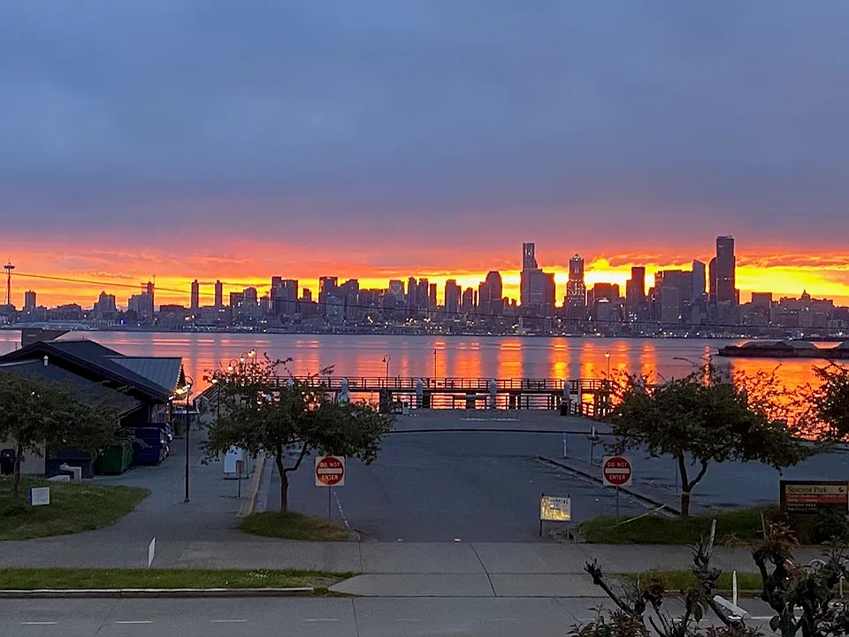 Sunrise behind the city glistening on the Puget Sound.