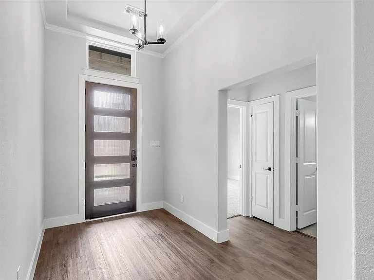 Modern entry door with frosted glass panels and transom window