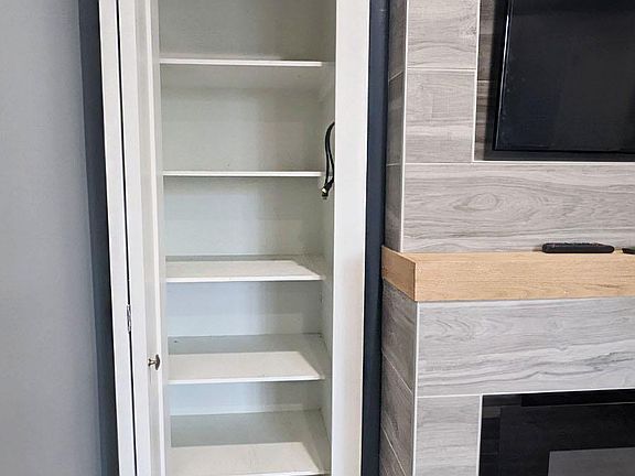 Great storage throughout, this storage is next to the TV / FIreplace