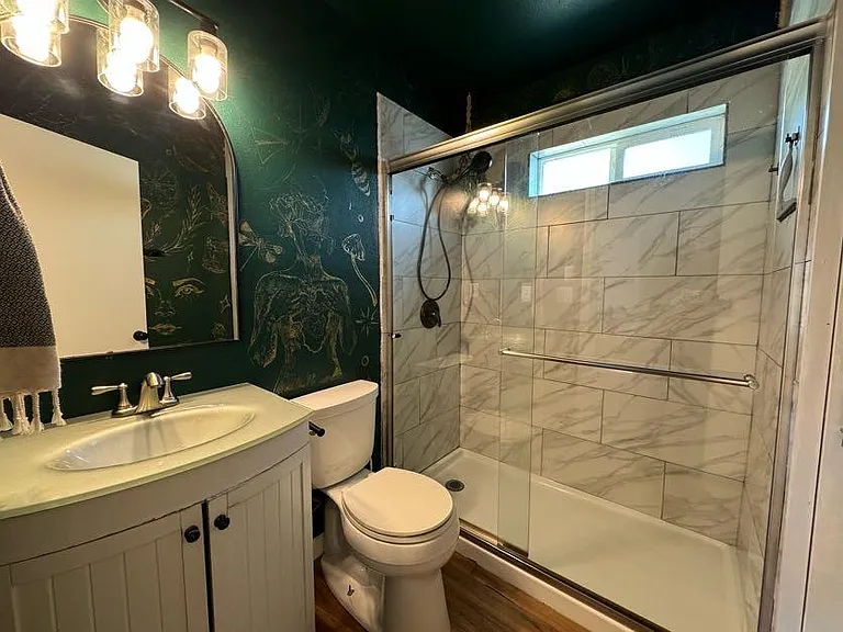 Bathroom on the main floor with marble tile walk in shower