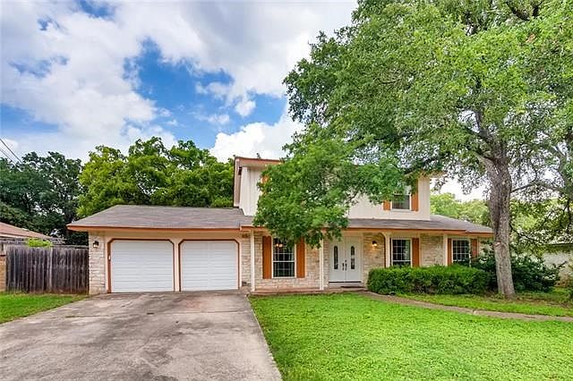 Beautiful home with large shade trees.