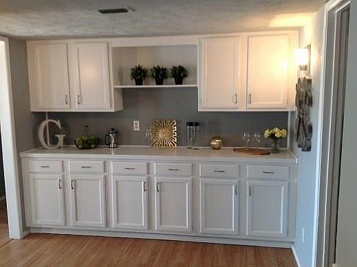 The freshly painted white cabinets make an excellent dry bar or butlers pantry off of the kitchen and dining rooms.