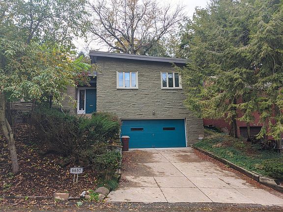 Front of house; 2 car garage and driveway