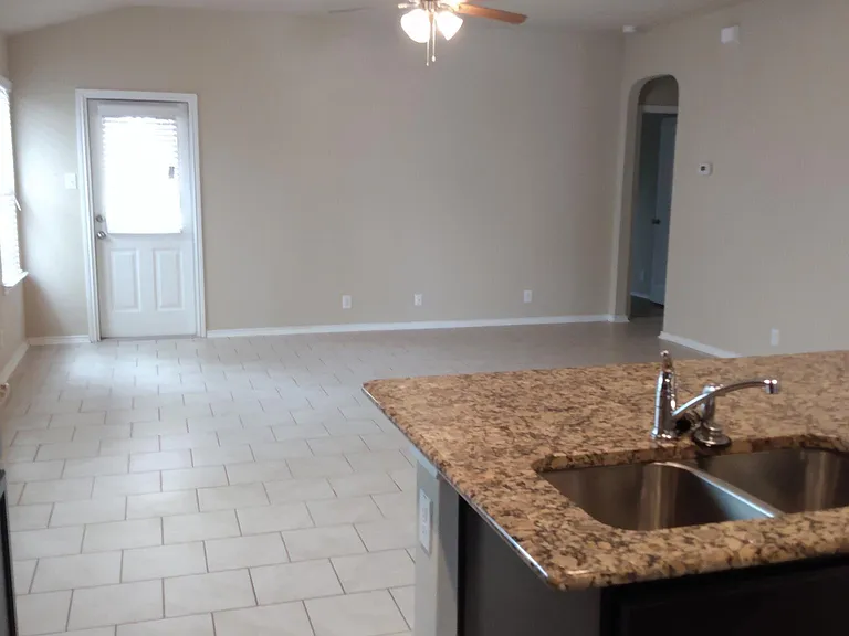 View from the kitchen to the family room to the back patio