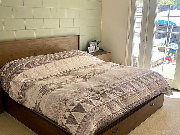 Bedroom 1 with French doors to backyard