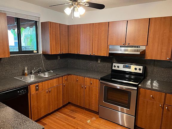 Clean and functional kitchen with Cherry wood cabinets.