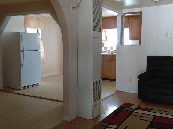 View of the front entrance into the living, dining and the kitchen