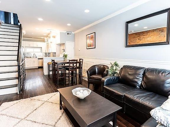 Walk in to an exquisite, open concept first floor great for entertaining, or watching the game. This first floor boasts many features such as a gorgeous, exposed brick wall, grand chandelier, large living room w/ smart tv, and dining area.