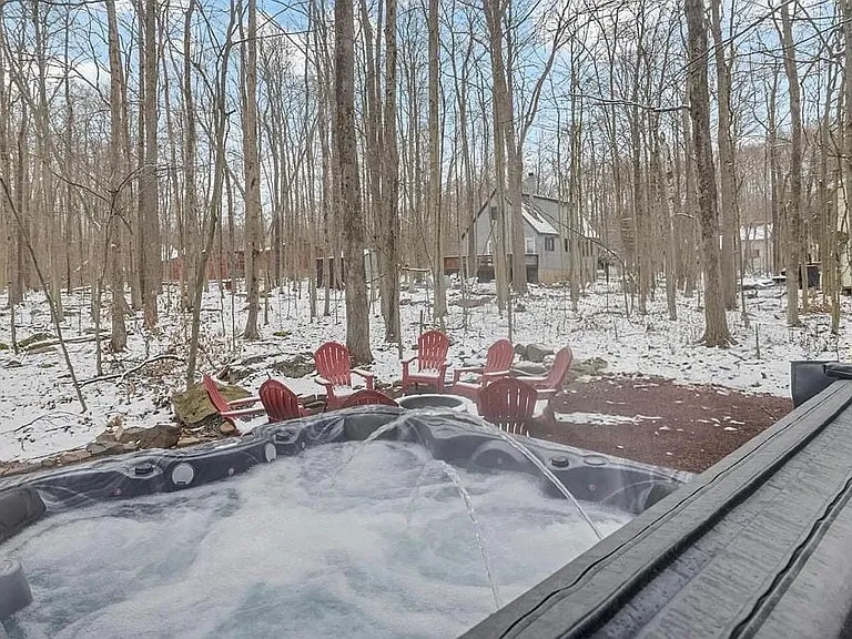 Hot Tub with Woodland Views _ Private hot tub overlooking a serene wooded setting. Hot tub maintenance included.