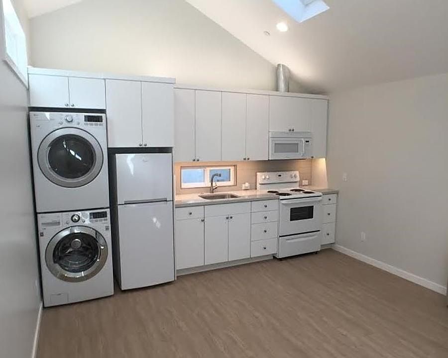 Kitchen and Great room with 2 skylights. One skylight opens.