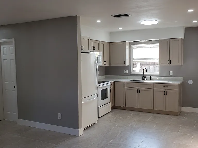 Overall Kitchen, Dining, Hall area. Window looking at back yard.
