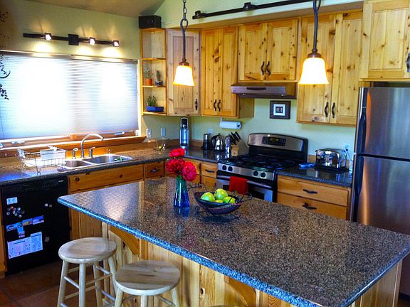 Granite counter tops and stainless appliances highlight this amazing, open kitchen.