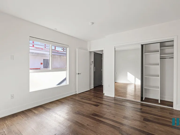 Bedroom with Recessed Lighting, Vinyl Flooring, Bathroom, Closet, and Large Windows