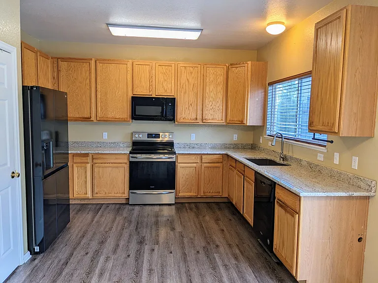 Spacious kitchen with granite counters and tons of cabinet space plus pantry. Tall ceilings ensure open feel of home. Recently upgraded appliances.