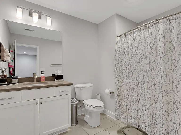 Spacious upstairs hall bath with quartz countertops, tile flooring and shower/tub combo