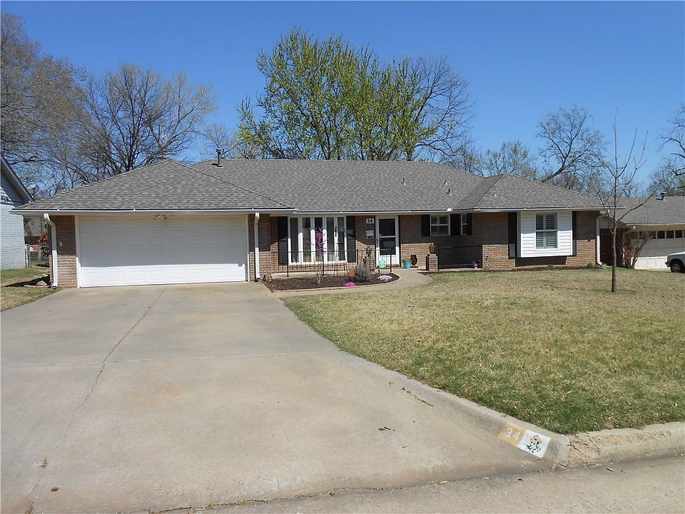 Great curb with white windows, black shutters, a front porch percent for sitting, and easy to maintain flower beds.