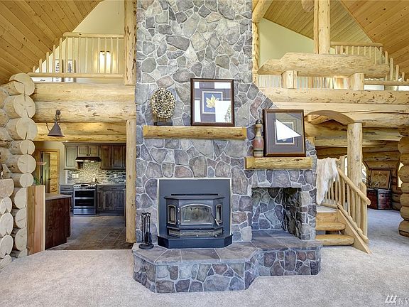 Huge fireplace in the center of great room. Beautiful floor to ceiling stone wood burning fireplace. 