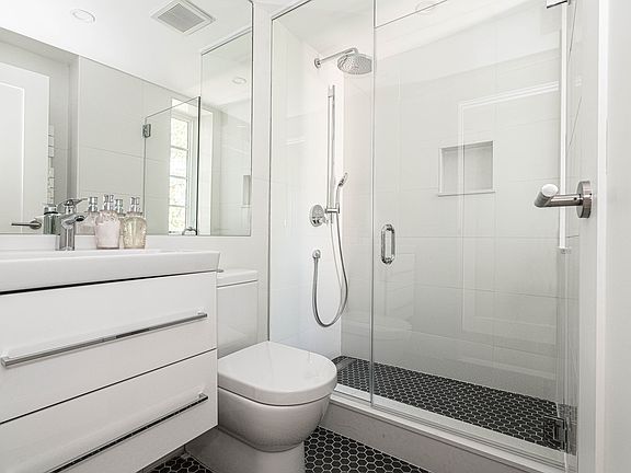 stylish bathroom with chrome fixtures and a rain shower