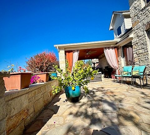 Outdoor kitchen with grill, refrigerator, wine fridge, tv, sink, etc