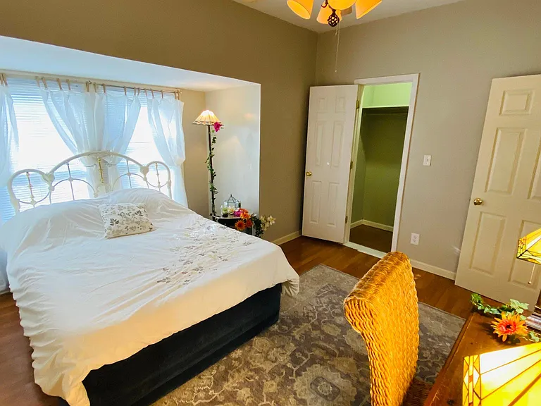 The Second bedroom's large Bay window has new white linen curtains with cordless mini blinds for Energy-saving. There is an energy-saving Reversible ceiling fan and a tall and wide closet.