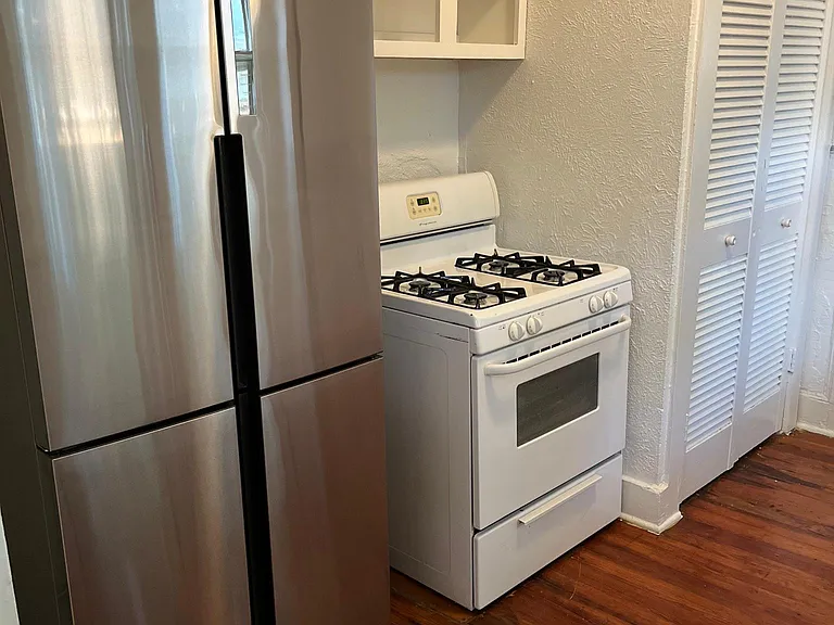 new stainless steel range with vent hood installed.
