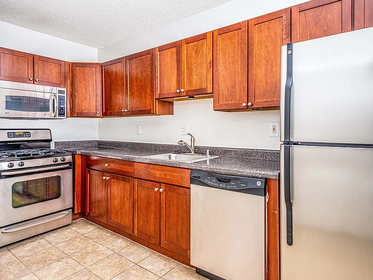 Updated kitchens with stainless steel appliances, cherry maple cabinets and gas range