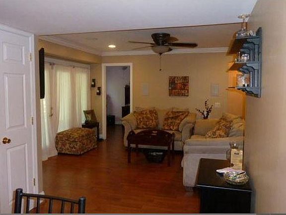 view from dining area of living room & doorway to bedroom #3 & door to pantry on left.