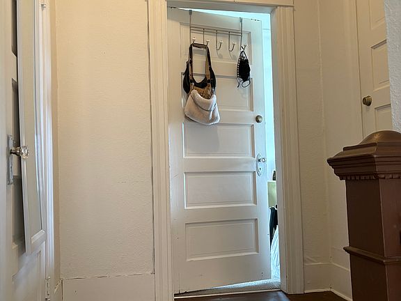 Landing at the top of the stairs. 
Left door is the coat closet, middle door leads to main living area and the door to the right to the first bedroom.