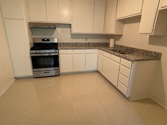 Fresh paint, new granite countertops with stainless steel sink and new stainless steel and black five burner stove and new stainless over head expose fan.