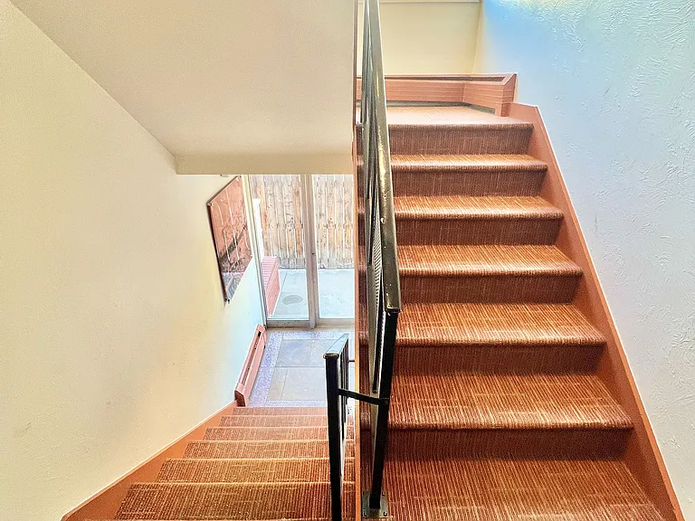 Experience the welcoming ascent with this bright and open staircase design.