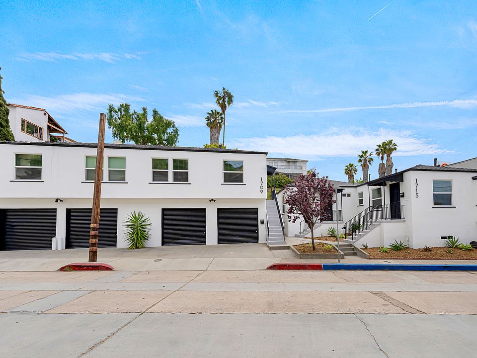 Front view. Garage is first on the left. Unit entrance is behind the red tree.