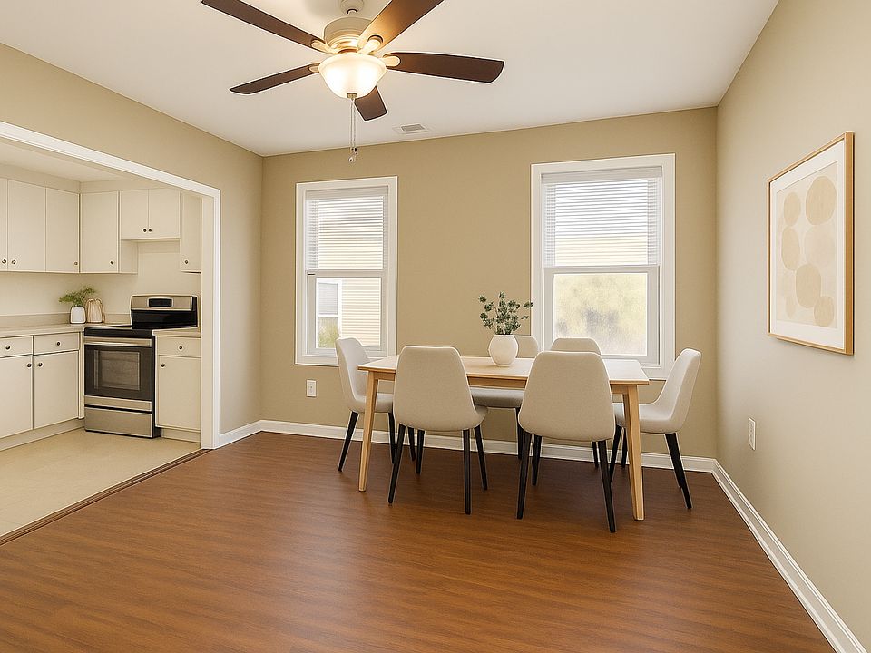Another virtually staged option if you prefer to use this space as a dining room! There is a window above the stove and a window above kitchen sink